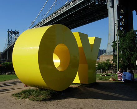 Deborah Kass, OY/YO, 2015, 8 x 17 x 5 ft., yellow painted aluminum, Brooklyn Bridge Park, Brooklyn, New York, commissioned by Two Trees Management Co. Photograph ©2016 Janice Carapellucci.